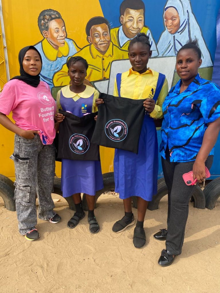 Children holding butterfly foundation branded bag